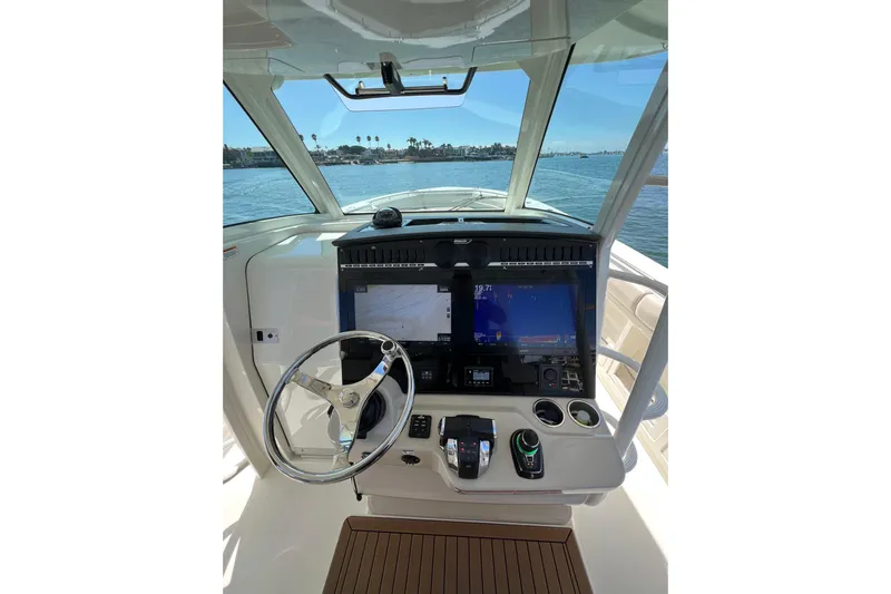 M22 Yacht Photos Pics 2019 Boston Whaler 380 Outrage helm with advanced navigation displays and controls.