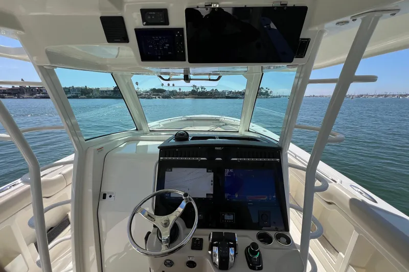 M22 Yacht Photos Pics 2019 Boston Whaler 380 Outrage helm with advanced navigation system on open water.