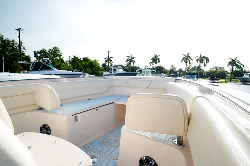  Yacht Photos Pics 2021 Grady-White Canyon 271 boat interior with seating and palm trees in background.