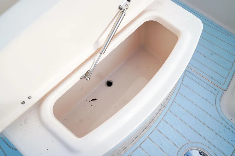  Yacht Photos Pics Grady-White Canyon 271 boat storage compartment, 2021 model, with open lid and blue flooring.