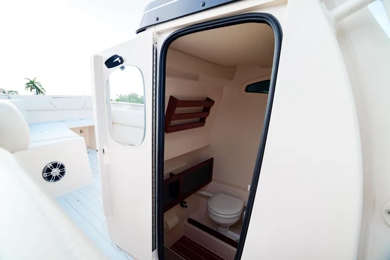  Yacht Photos Pics 2021 Grady-White Canyon 271 boat interior with compact bathroom.