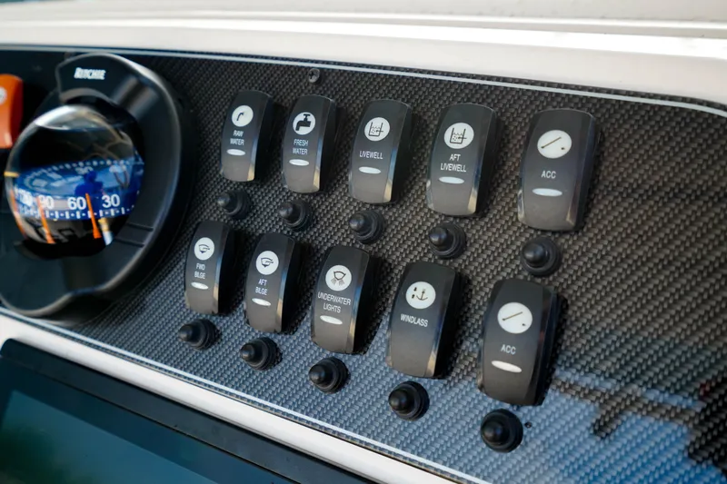  Yacht Photos Pics Control panel of 2021 Grady-White Canyon 271 boat with various switches and compass.