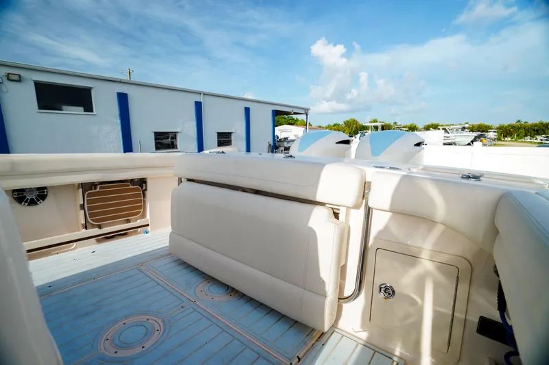  Yacht Photos Pics 2021 Grady-White Canyon 271 boat interior with seating and storage, under a clear blue sky.