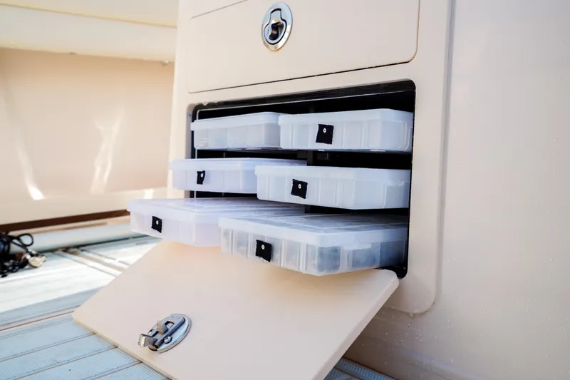  Yacht Photos Pics Grady-White Canyon 271 boat storage compartments with organized tackle boxes, 2021 model.