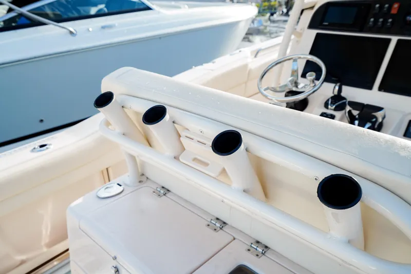  Yacht Photos Pics 2021 Grady-White Canyon 271 boat interior with rod holders and steering wheel.