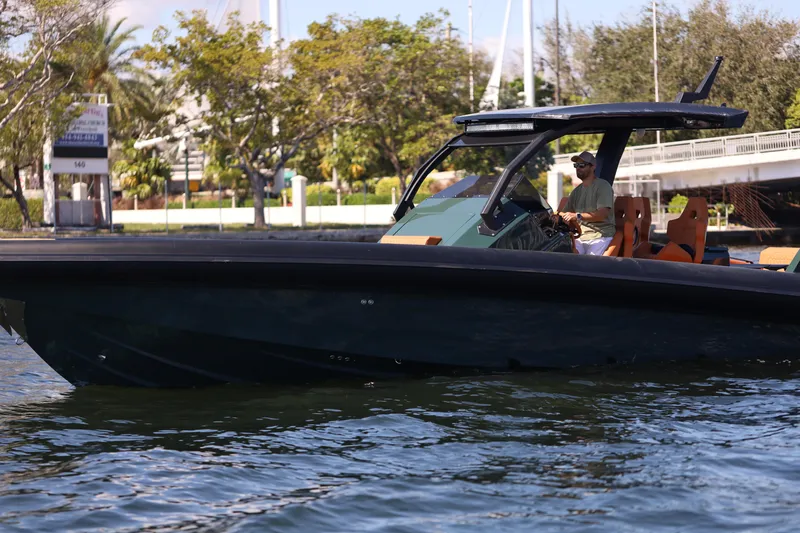 New 2025 Skipper 38 Twin 400 V10 Yacht Photos Pics 2025 Skipper-BSK 38 boat cruising on a calm waterway, surrounded by lush greenery.