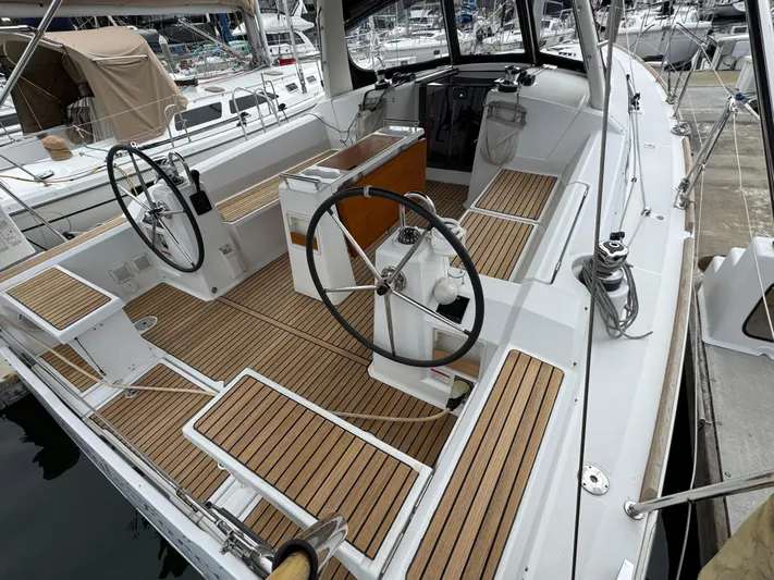 Gayle Force Yacht Photos Pics 2014 Beneteau Oceanis 38 sailboat cockpit with dual steering wheels and teak flooring.