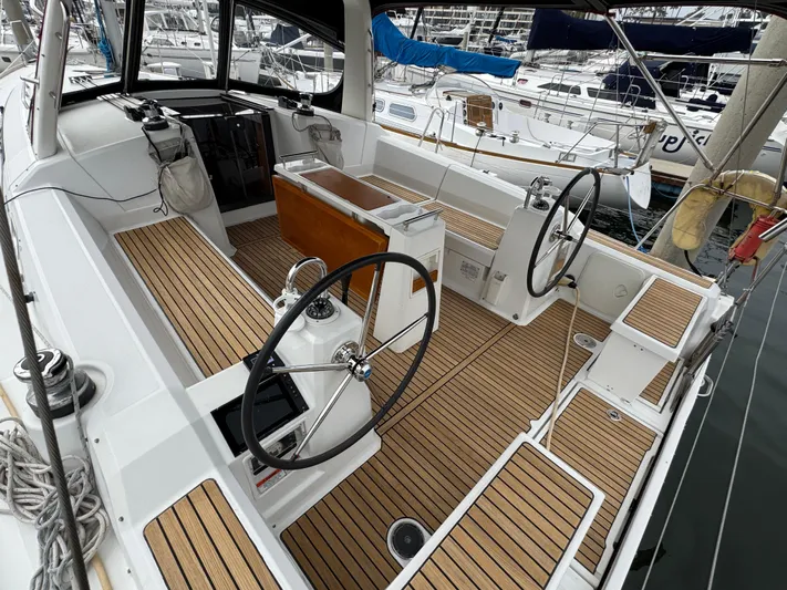 Gayle Force Yacht Photos Pics 2014 Beneteau Oceanis 38 sailboat cockpit with dual steering wheels and teak flooring.