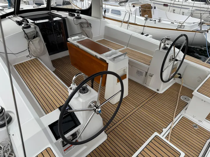 Gayle Force Yacht Photos Pics 2014 Beneteau Oceanis 38 sailboat cockpit with dual steering wheels and teak flooring.