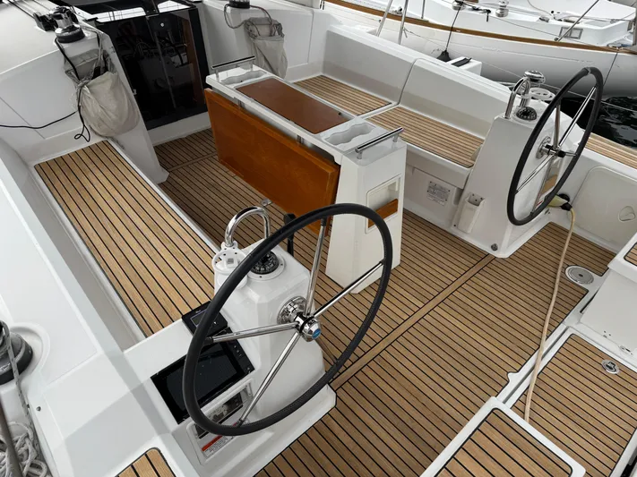 Gayle Force Yacht Photos Pics Cockpit of 2014 Beneteau Oceanis 38 sailboat with dual steering wheels and teak flooring.
