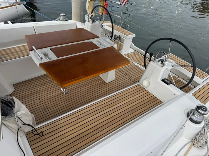 Gayle Force Yacht Photos Pics 2014 Beneteau Oceanis 38 sailboat cockpit with wooden table and dual steering wheels.