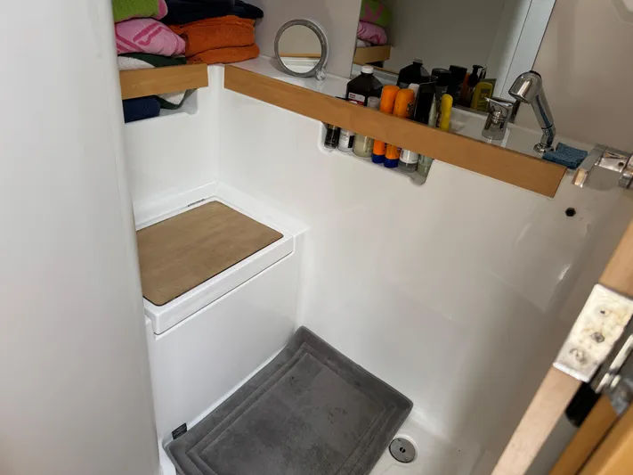 Gayle Force Yacht Photos Pics Bathroom interior of 2014 Beneteau Oceanis 38 yacht with sink and storage shelves.