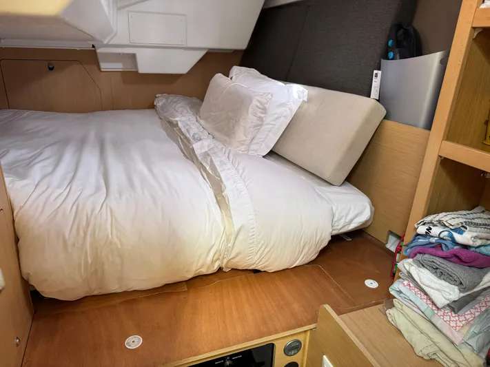Gayle Force Yacht Photos Pics Cozy cabin interior of 2014 Beneteau Oceanis 38 sailboat with neatly arranged bedding.