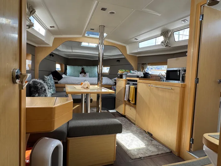 Gayle Force Yacht Photos Pics Interior of 2014 Beneteau Oceanis 38 sailboat, featuring modern kitchen and cozy seating area.