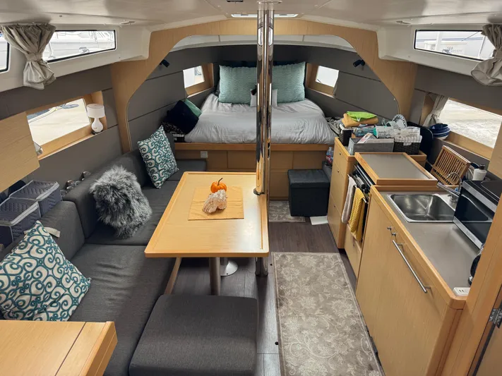 Gayle Force Yacht Photos Pics Interior of 2014 Beneteau Oceanis 38 sailboat with cozy seating, kitchen, and bed.
