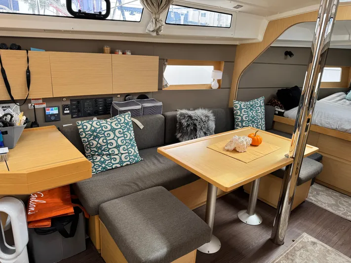 Gayle Force Yacht Photos Pics Interior of 2014 Beneteau Oceanis 38 sailboat with cozy seating and dining area.