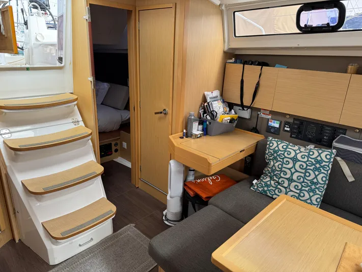 Gayle Force Yacht Photos Pics Interior of 2014 Beneteau Oceanis 38 sailboat with cozy seating and wooden cabinetry.