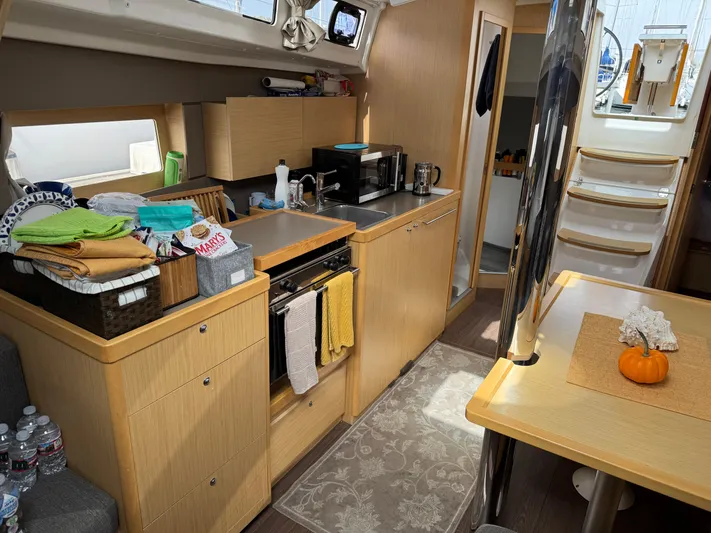 Gayle Force Yacht Photos Pics Interior of 2014 Beneteau Oceanis 38 sailboat with modern kitchen and dining area.