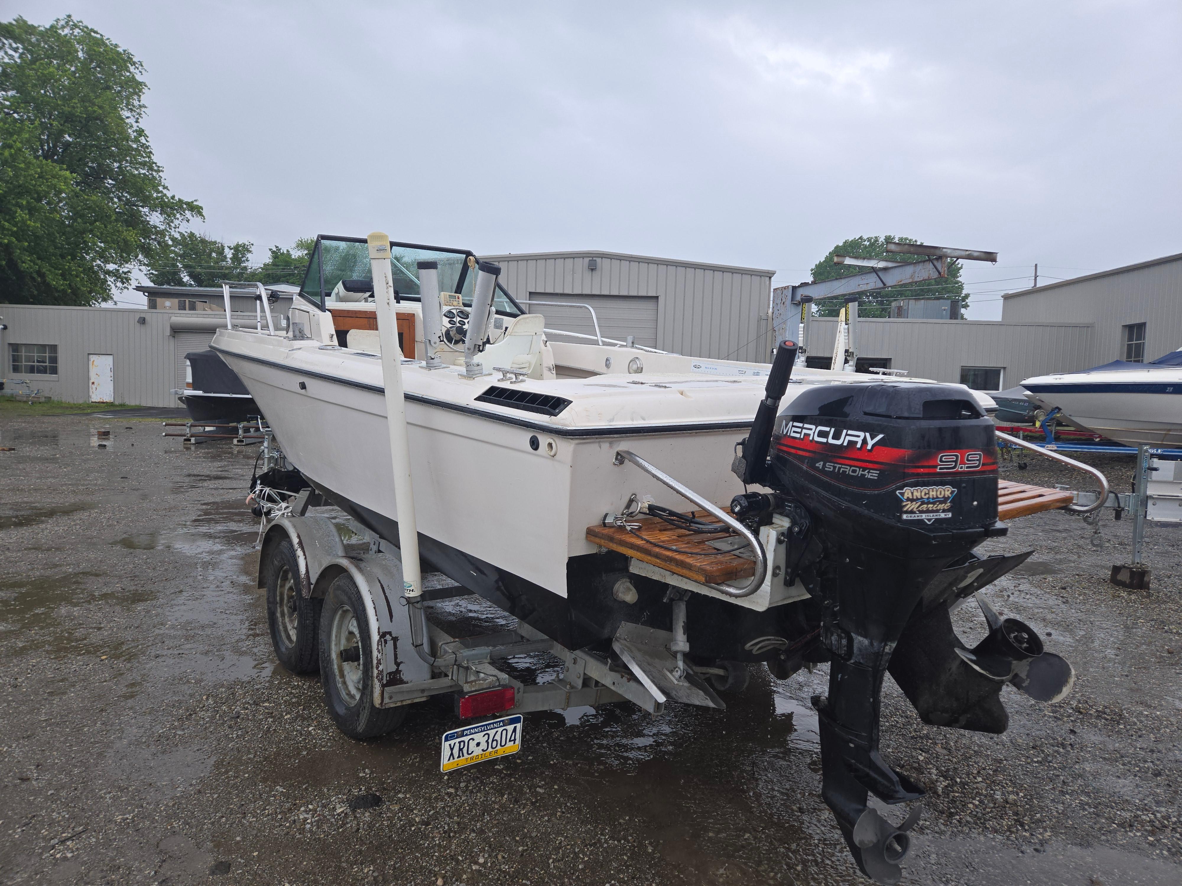 1992 Dixie 21 boat on trailer with Mercury outboard motor, parked outdoors.
