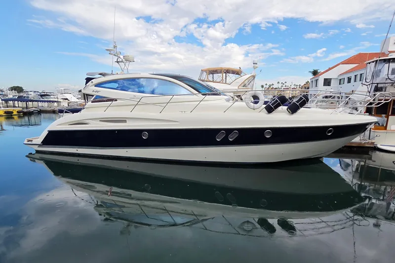 Nina & Alexander Yacht Photos Pics 2007 Cranchi Mediterranee 47 HT yacht docked in a marina under a blue sky.