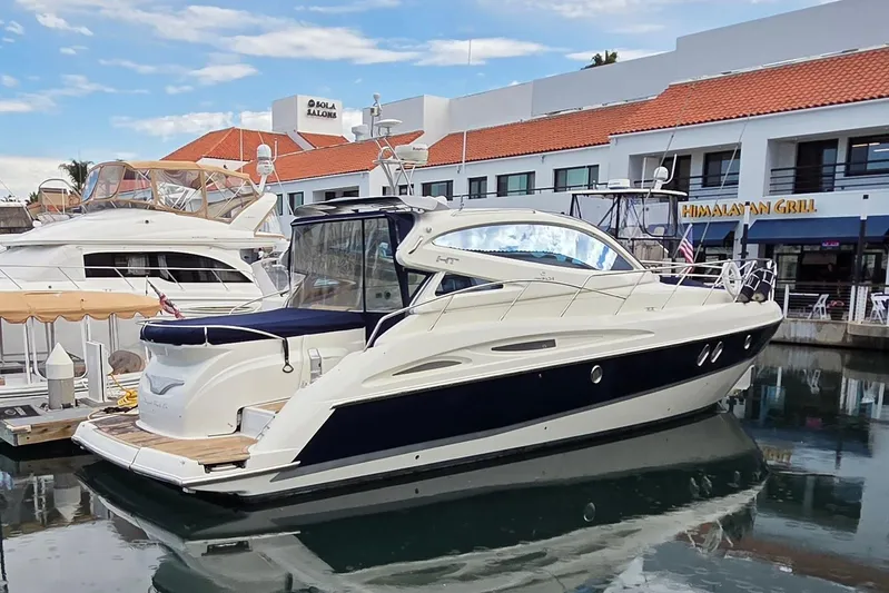 Nina & Alexander Yacht Photos Pics 2007 Cranchi Mediterranee 47 HT yacht docked near waterfront restaurants.