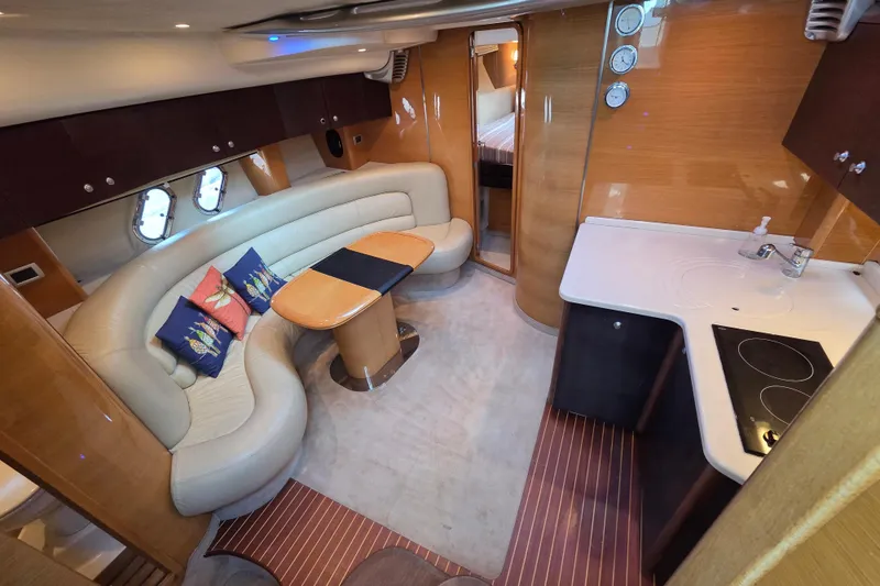 Nina & Alexander Yacht Photos Pics Luxurious interior of 2007 Cranchi Mediterranee 47 HT yacht with modern kitchen and seating area.