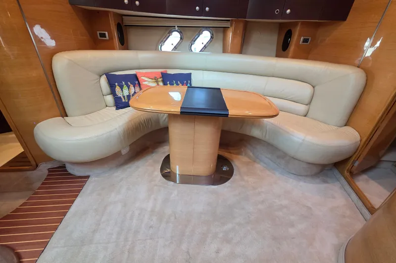 Nina & Alexander Yacht Photos Pics Luxurious interior of 2007 Cranchi Mediterranee 47 HT yacht with curved seating and table.