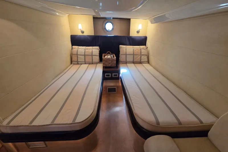 Nina & Alexander Yacht Photos Pics Interior cabin of 2007 Cranchi Mediterranee 47 HT yacht with twin beds and soft lighting.