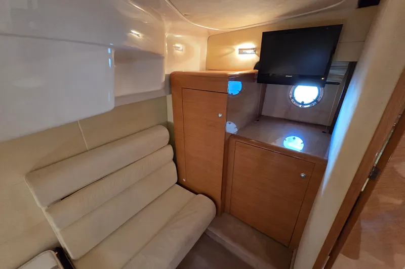 Nina & Alexander Yacht Photos Pics Interior of 2007 Cranchi Mediterranee 47 HT yacht with seating and TV.