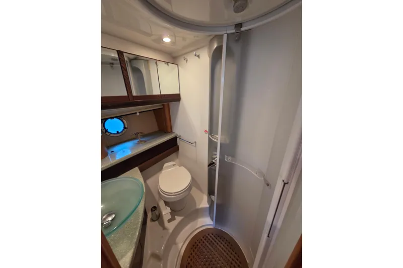 Nina & Alexander Yacht Photos Pics Bathroom interior of 2007 Cranchi Mediterranee 47 HT yacht, featuring modern fixtures and porthole.