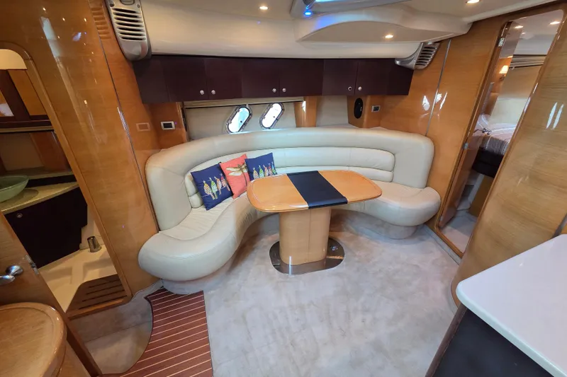 Nina & Alexander Yacht Photos Pics Luxurious interior of 2007 Cranchi Mediterranee 47 HT yacht with elegant seating and table.