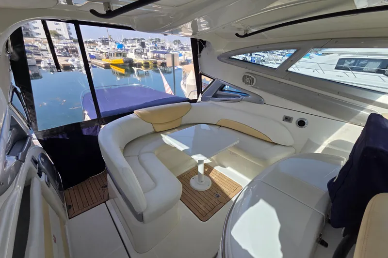 Nina & Alexander Yacht Photos Pics Luxurious 2007 Cranchi Mediterranee 47 HT yacht interior with elegant seating and marina view.