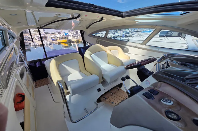 Nina & Alexander Yacht Photos Pics Interior of 2007 Cranchi Mediterranee 47 HT yacht with luxurious seating and helm.