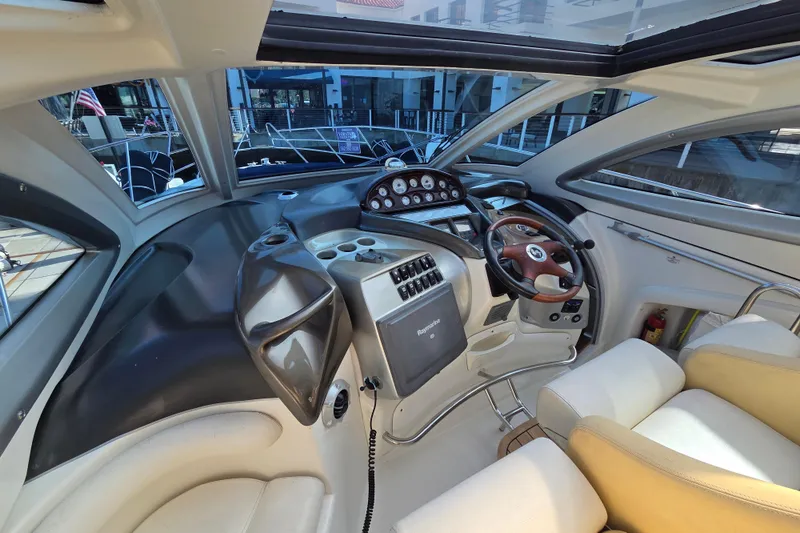 Nina & Alexander Yacht Photos Pics Interior cockpit of 2007 Cranchi Mediterranee 47 HT yacht, featuring modern controls and leather seating.