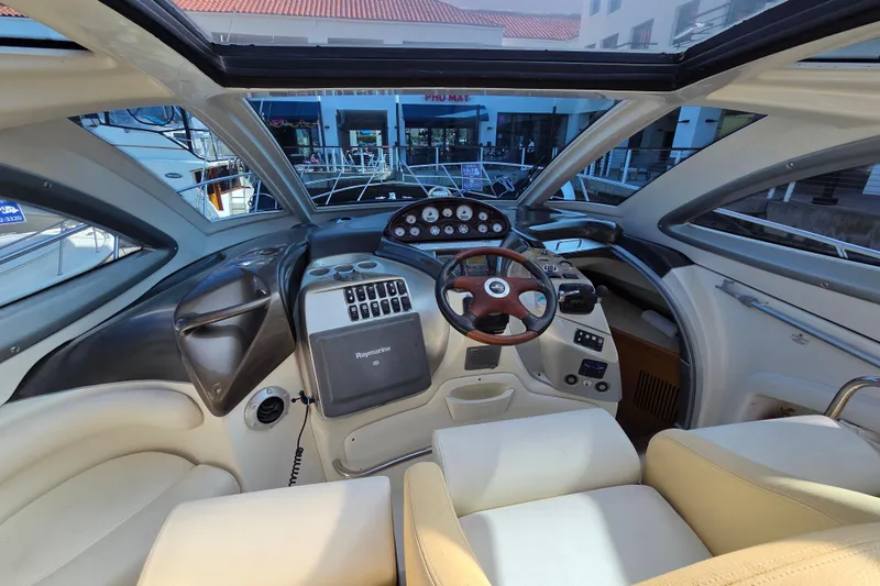 Nina & Alexander Yacht Photos Pics Interior cockpit of 2007 Cranchi Mediterranee 47 HT yacht, featuring modern controls and steering.