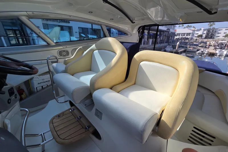 Nina & Alexander Yacht Photos Pics Interior of 2007 Cranchi Mediterranee 47 HT yacht with luxurious seating and marina view.