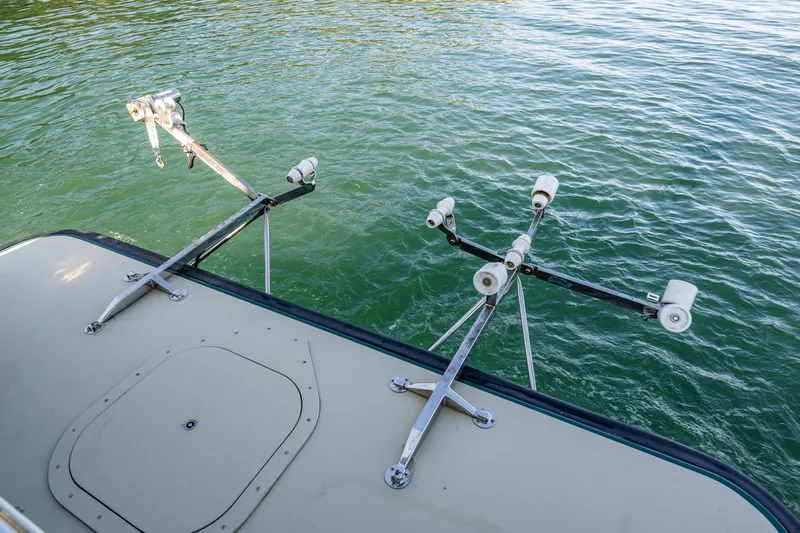 Consequence Free Yacht Photos Pics 2009 Coastal Craft 400 IPS boat with fishing rod holders on calm water.