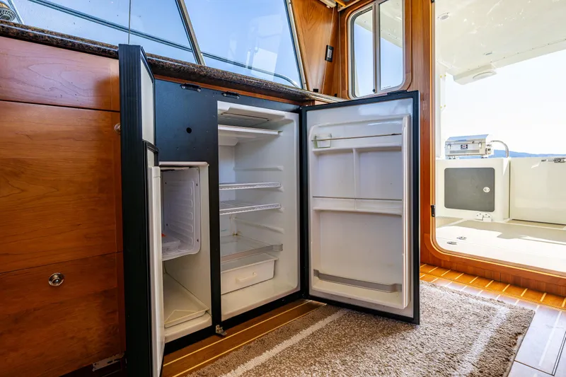 Consequence Free Yacht Photos Pics Interior of 2009 Coastal Craft 400 IPS yacht with open refrigerator.