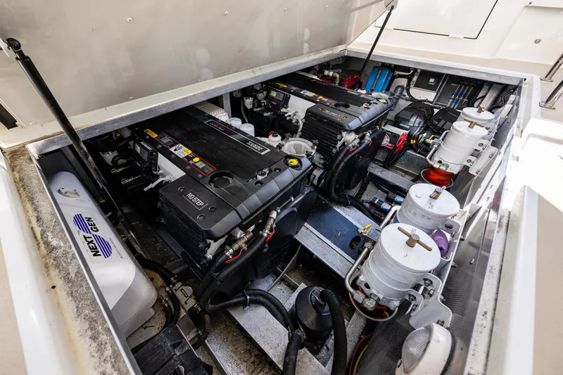 Consequence Free Yacht Photos Pics Engine compartment of a 2009 Coastal Craft 400 IPS boat, showcasing dual engines and components.