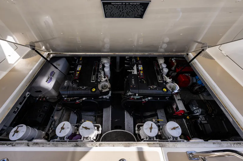 Consequence Free Yacht Photos Pics Engine compartment of 2009 Coastal Craft 400 IPS yacht, showcasing dual engines and mechanical components.