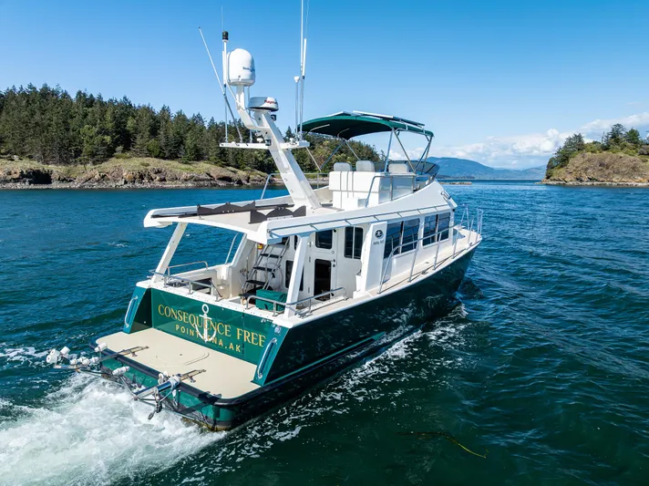 Consequence Free Yacht Photos Pics 2009 Coastal Craft 400 IPS yacht cruising in scenic waters with lush islands.