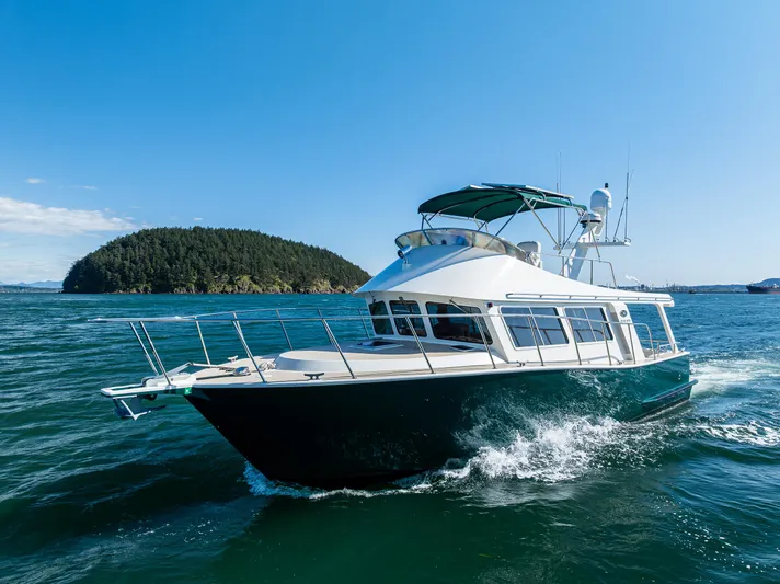 Consequence Free Yacht Photos Pics 2009 Coastal Craft 400 IPS yacht cruising on open water near an island.