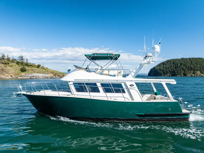 Consequence Free Yacht Photos Pics 2009 Coastal Craft 400 IPS yacht cruising on clear blue waters.