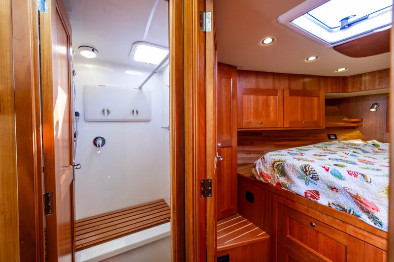 Consequence Free Yacht Photos Pics Luxurious 2009 Coastal Craft 400 IPS cabin interior with wood finish and cozy bedding.
