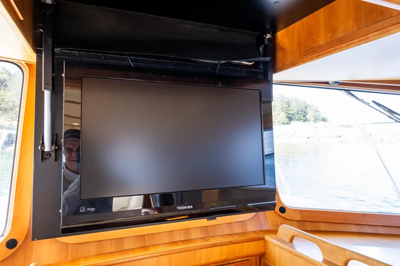Consequence Free Yacht Photos Pics Toshiba TV inside 2009 Coastal Craft 400 IPS yacht, wooden interior, window view.
