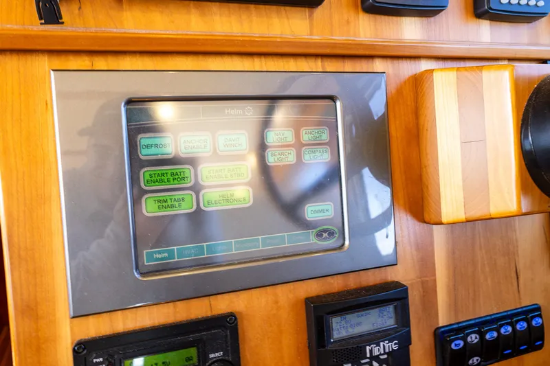 Consequence Free Yacht Photos Pics Control panel of a 2009 Coastal Craft 400 IPS boat, featuring various electronic displays.