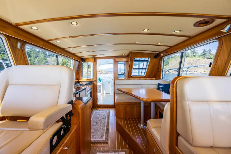 Consequence Free Yacht Photos Pics Luxurious interior of 2009 Coastal Craft 400 IPS yacht with wood finish and plush seating.