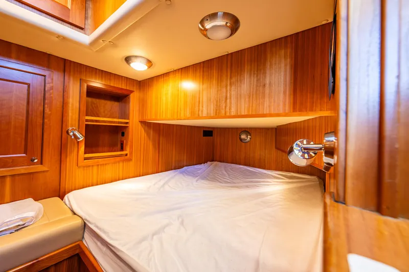 Consequence Free Yacht Photos Pics Cozy cabin interior of 2009 Coastal Craft 400 IPS yacht with wooden paneling and lighting.