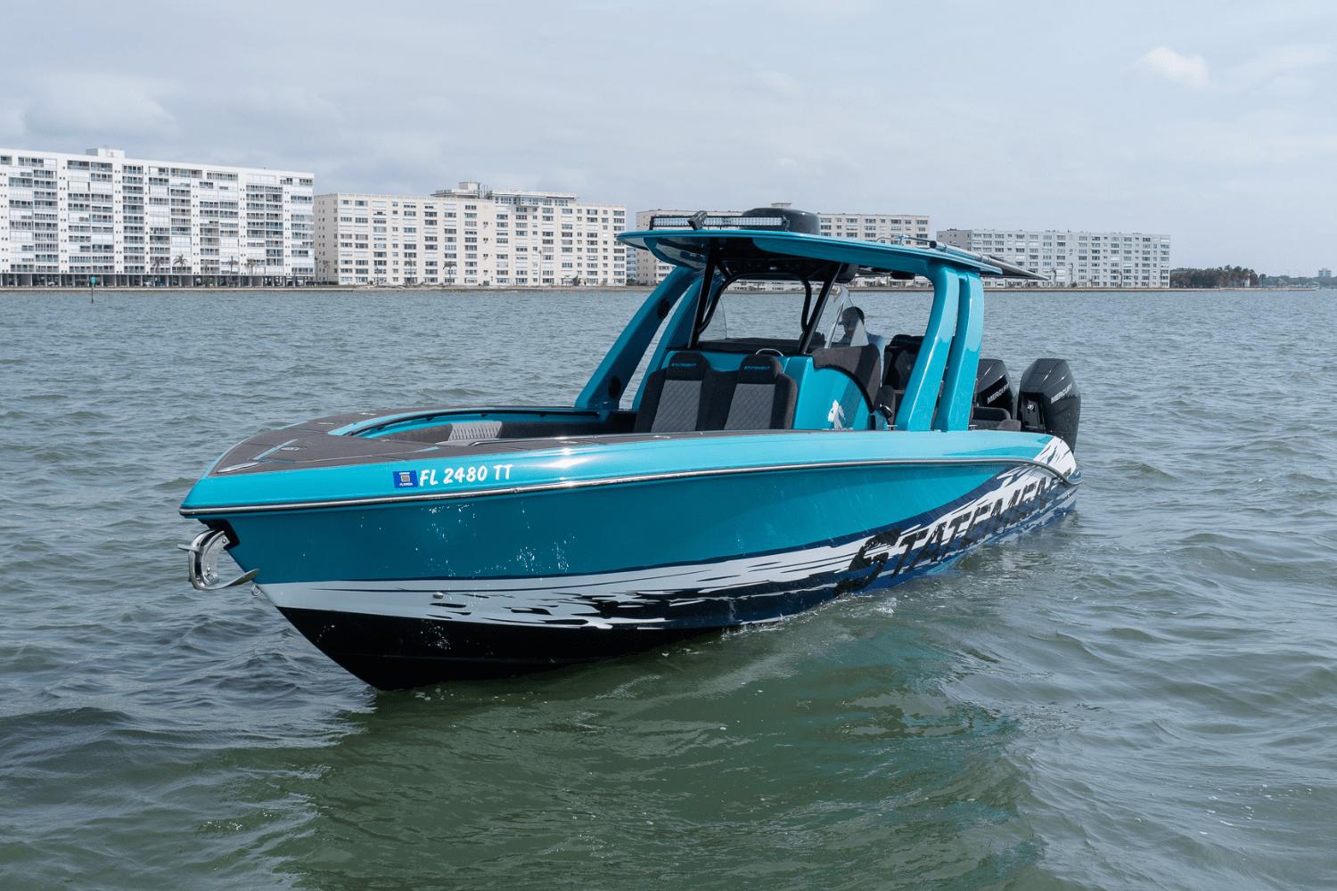 2024 Statement 38 Open boat on water, with cityscape background.