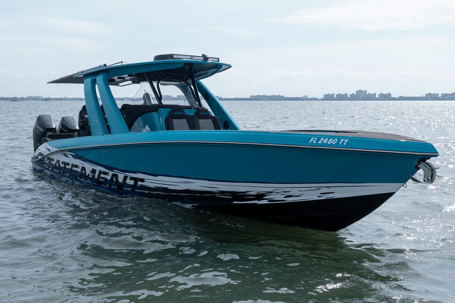 2024 Statement 38 Open boat on water, sleek design, vibrant blue color, city skyline in background.